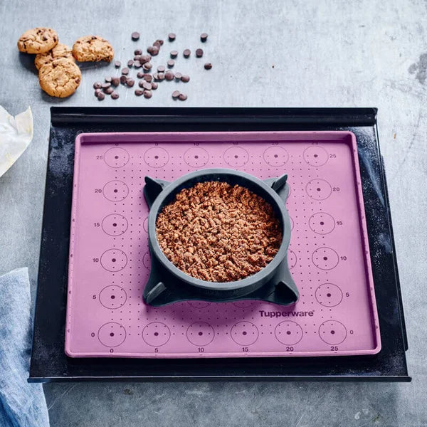 Tupperware Micro Pro Grill Ring with food on a purple silicone baking mat and cookies.