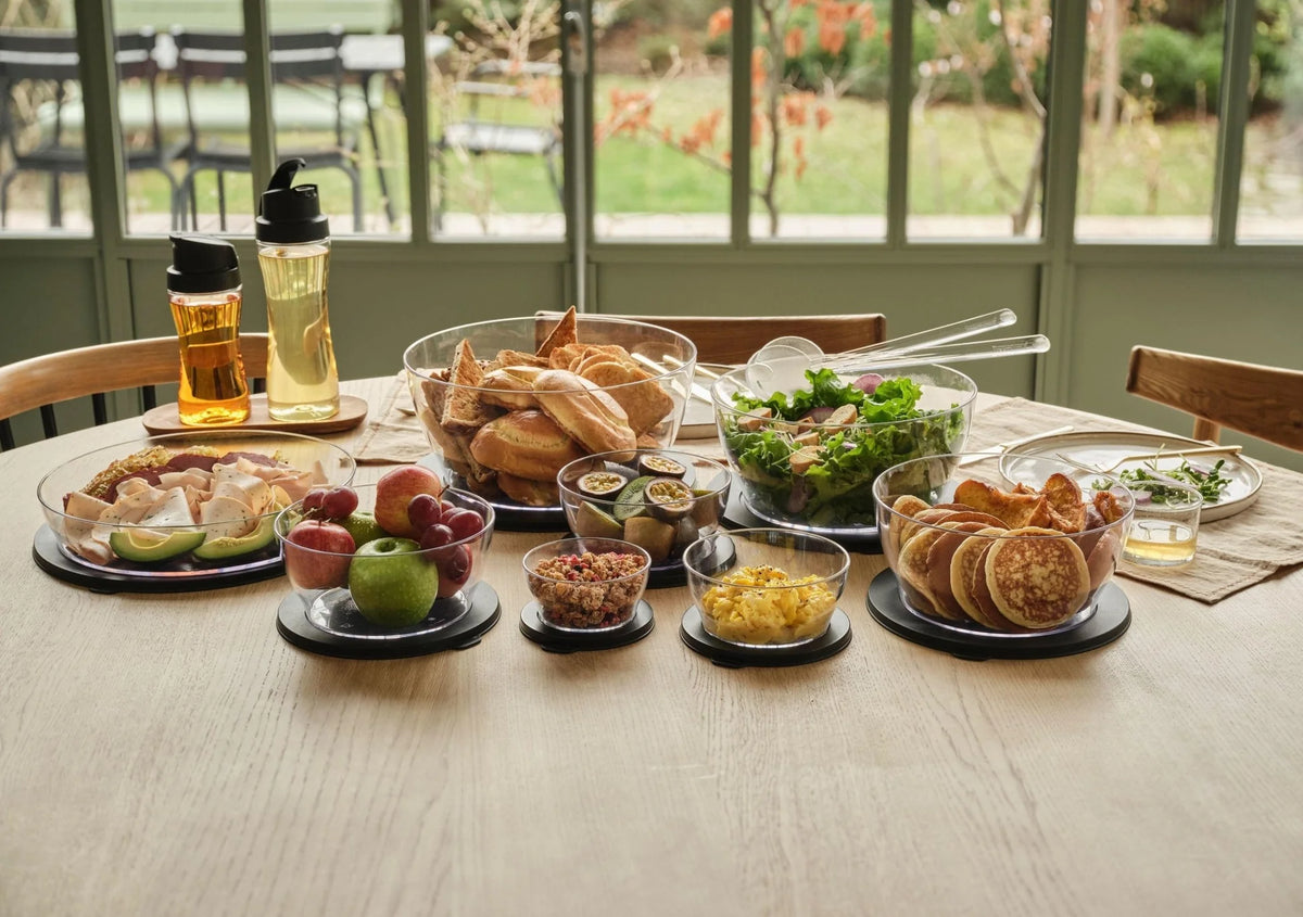 Assorted fresh foods in clear eco-friendly salad and storage bowls on a kitchen table