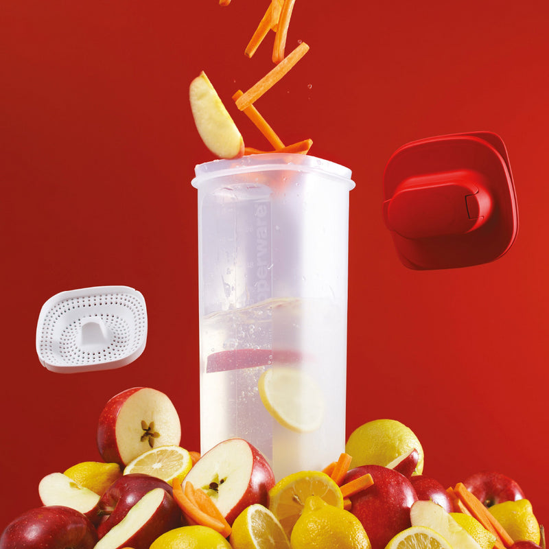 Tupperware square refrigerator pitcher with fruit and vegetables on a red background