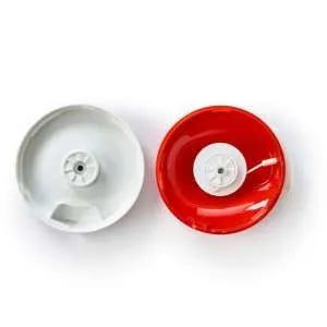 Top view of two kitchen chopper lids, one white and one red, on a white background.