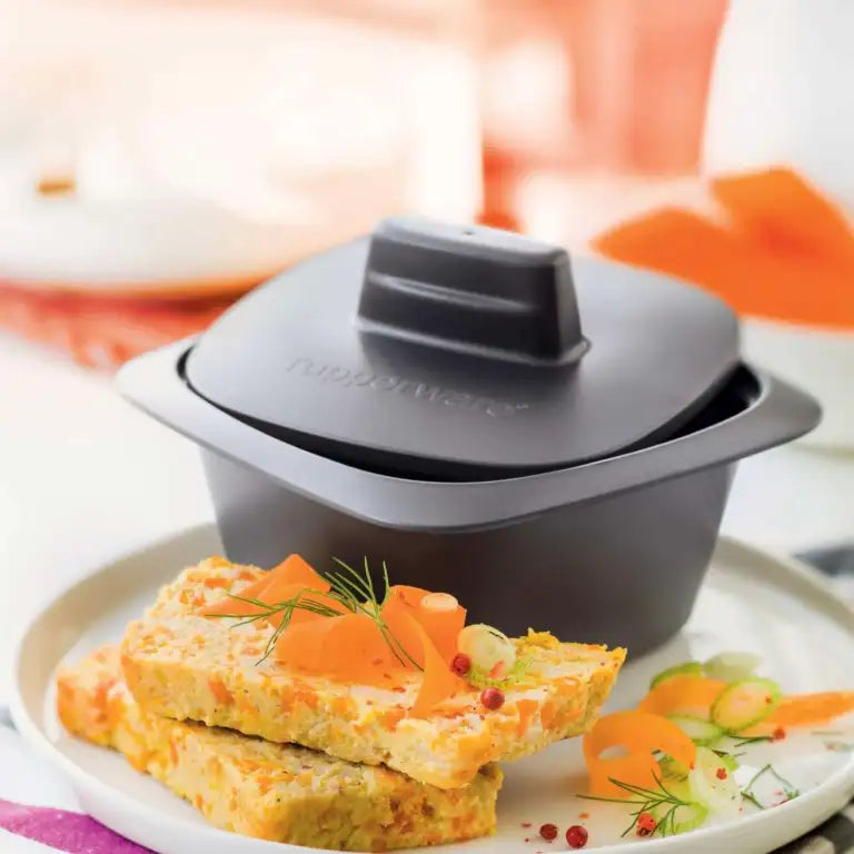 Tupperware UltraPro Cocotte with cooked vegetable slices served on a white plate.