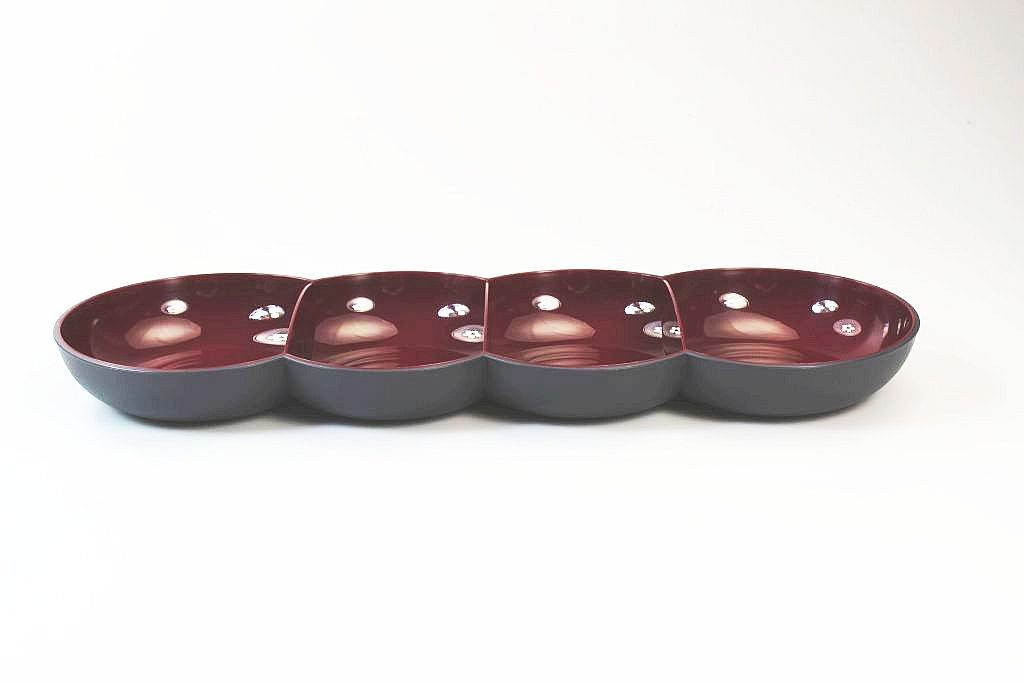 Four-section maroon and black ceramic serving dish on white background