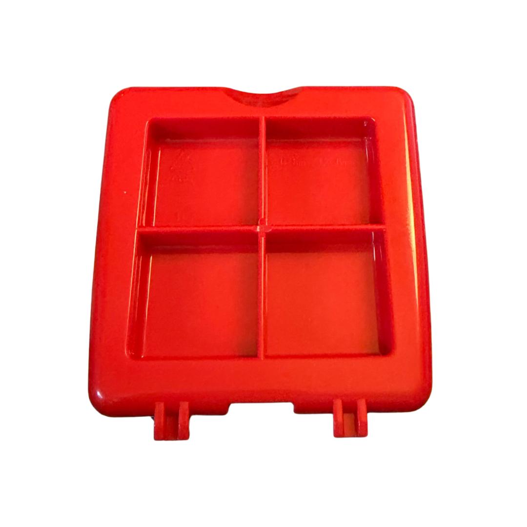 Red plastic kitchen tool with four square compartments, perfect for food prep or portioning