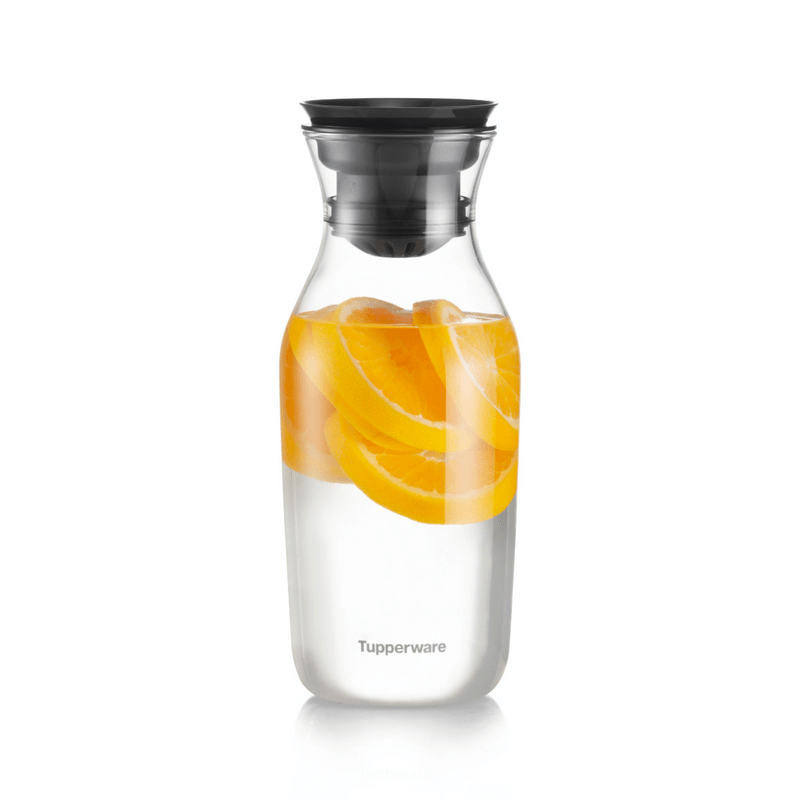 Clear glass water carafe with black lid, filled with orange slices and water