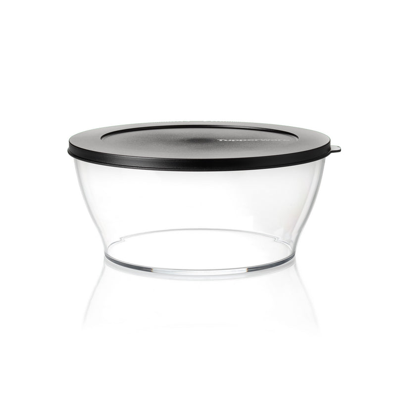 Transparent food storage container with black lid on white background