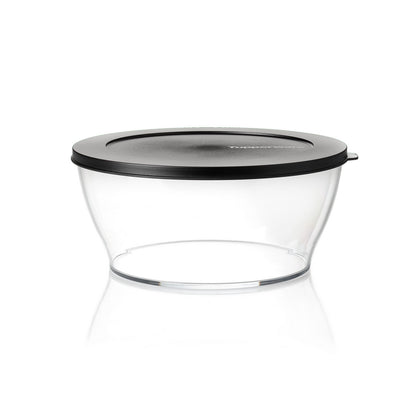 Transparent food storage container with black lid on white background