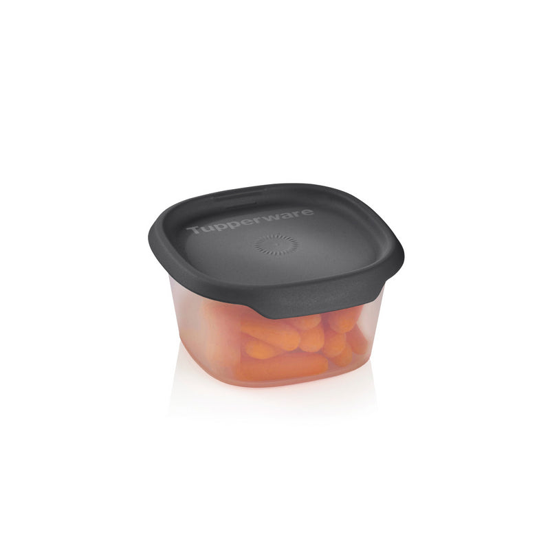 Plastic food storage container with black lid and orange snacks inside on white background
