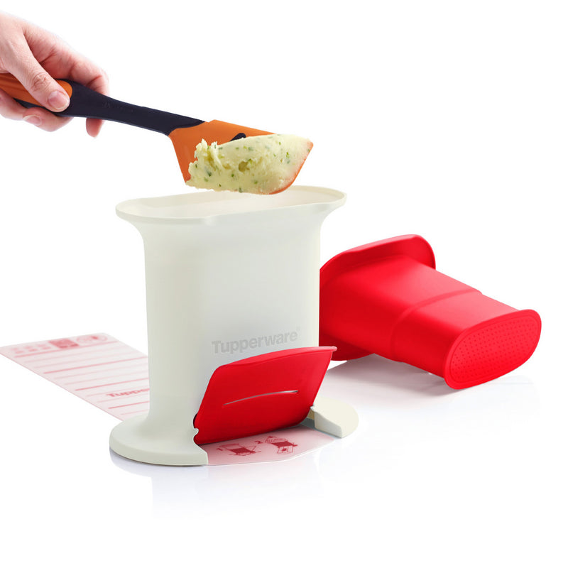 Red and white silicone kitchen tool for food preparation with spatula and mashed vegetables