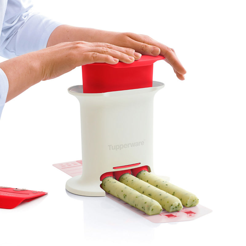 Herb butter maker kitchen tool creating uniform herb butter sticks on a white table