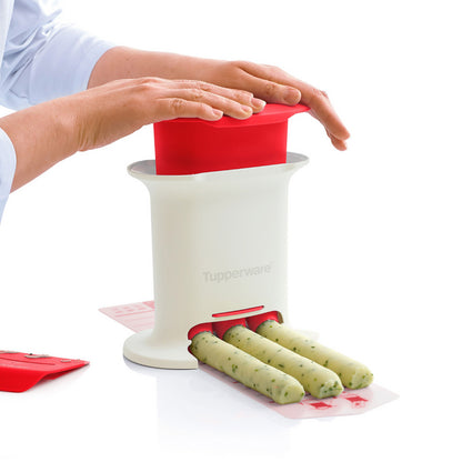 Herb butter maker kitchen tool creating uniform herb butter sticks on a white table