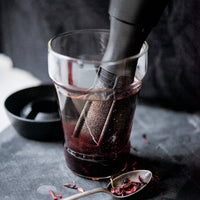 Handmixer mengt rode saus in glas, perfect keukengereedschap voor culinaire avonturen