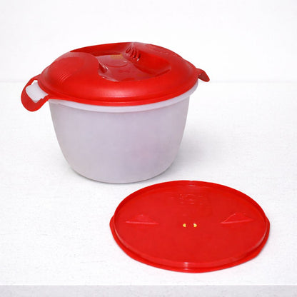 Plastic mixing bowl with red lid and handle, extra red lid beside it, on white surface