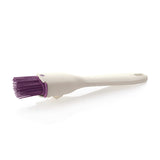 White silicone pastry brush with purple bristles on a white background, kitchen accessory
