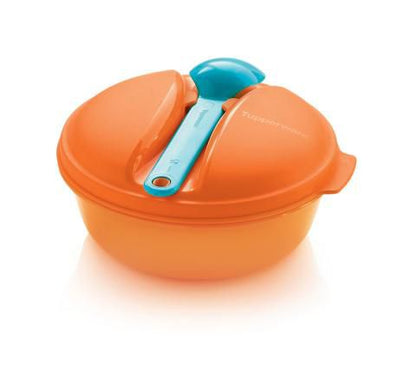 Orange microwave-safe mixing bowl with lid and a blue plastic serving spoon