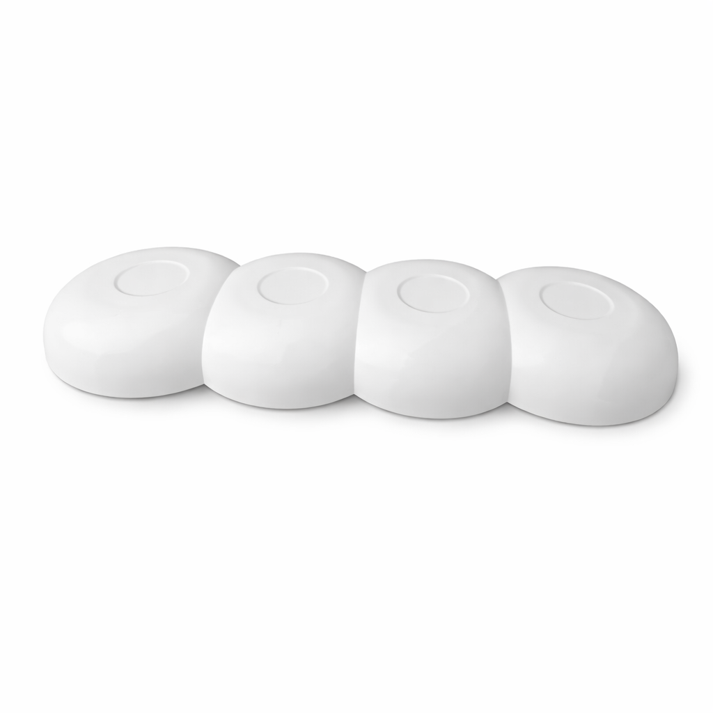 White ceramic kitchen tool rest with four sections, modern minimalist design.