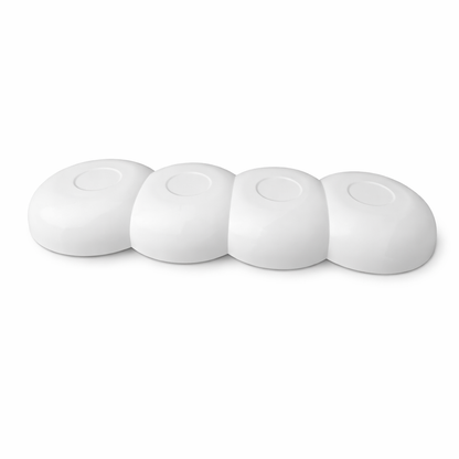 White ceramic kitchen tool rest with four sections, modern minimalist design.