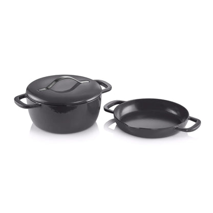 Black cast iron Dutch oven with lid and matching shallow pan, isolated on white background