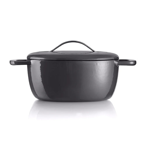 Black cast iron Dutch oven with lid and handles on white background