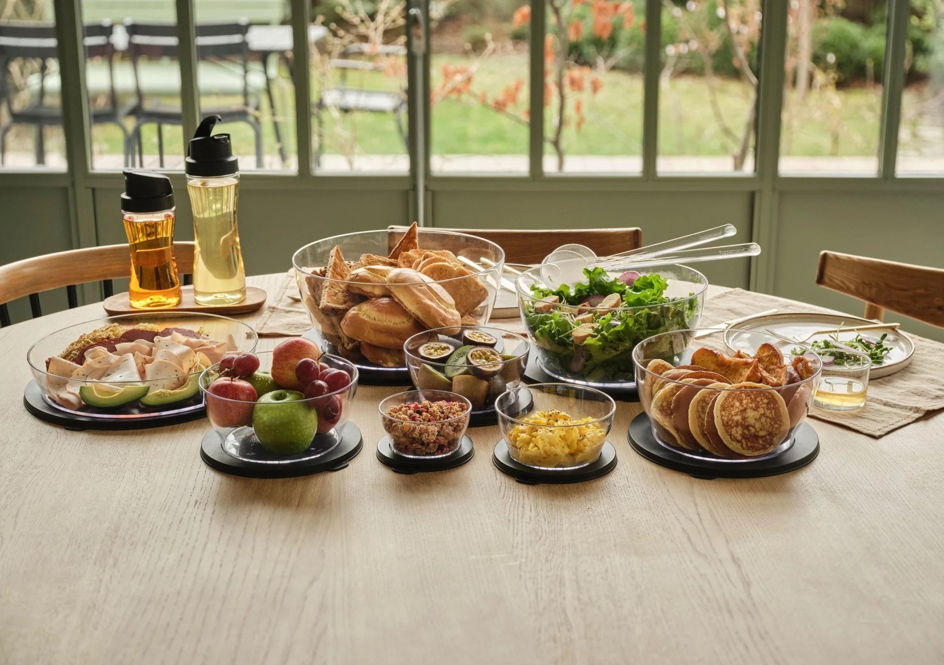 Assorted fresh foods in clear eco-friendly salad and storage bowls on a kitchen table