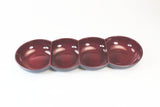 Four-section maroon ceramic appetizer serving dish on white background