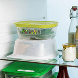 Rectangular Tupperware cheese container with yellow lid in a refrigerator