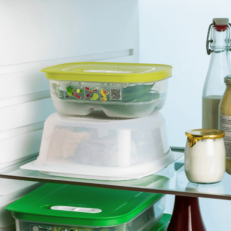 Rectangular Tupperware cheese container with yellow lid in a refrigerator