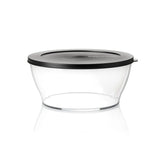 Transparent food storage container with black lid on white background