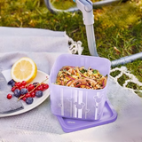Tupperware Cubix Disney 1 Liter purple food container with salad on a white cloth