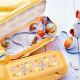 Yellow Tupperware egg box with decorated Easter eggs and bunny patterns.
