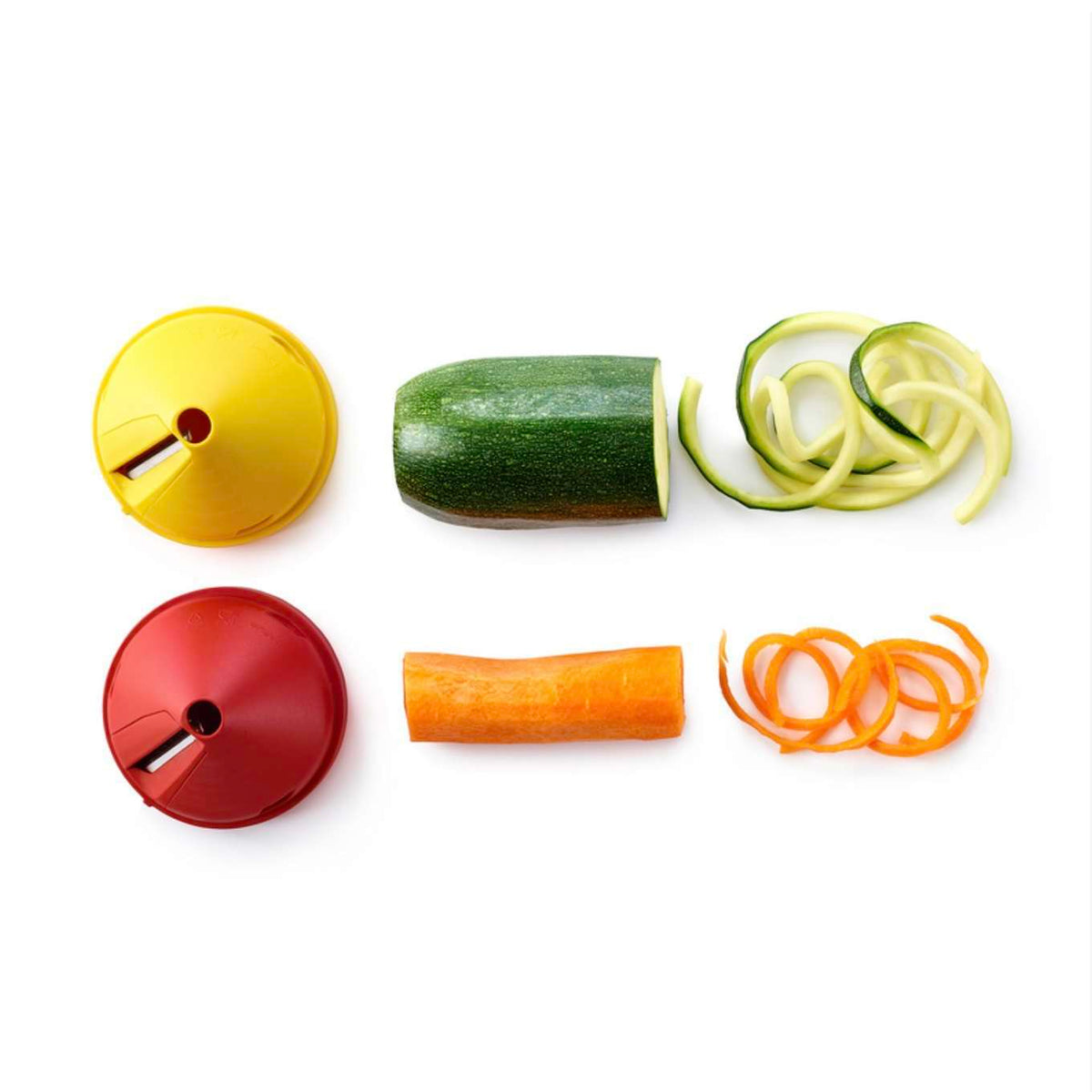 Spiral vegetable slicers with zucchini and carrot creating spiral veggie noodles on white background