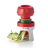 Handheld spiralizer kitchen tool making zucchini noodles on white background
