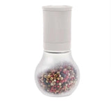 Tupperware pepper mill with a clear frosted glass base filled with multicolored peppercorns