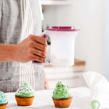 Person using a Tupperware Poeder Zeef to dust powdered sugar over green frosted cupcakes.