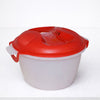 Plastic microwave cooking bowl with red vented lid on white counter