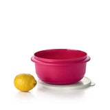 Pink Tupperware Ultimate Mixing Bowl with white lid and a yellow lemon on a white background