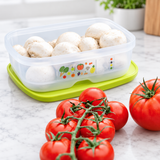 Tupperware VentSmart food container with white mushrooms on a green cutting board with tomatoes