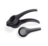 Black Tupperware citrus press and zester kitchen tools on white background